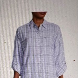 Boyfriend fit oversized button up blouse with roll cuff sleeve. 100% rayon.